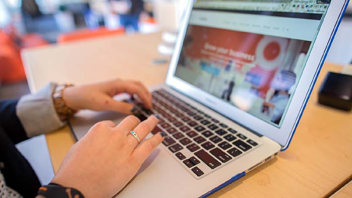 Photo of a woman using a laptop computer - What Every Seller Should Know About Today's Home Buyers