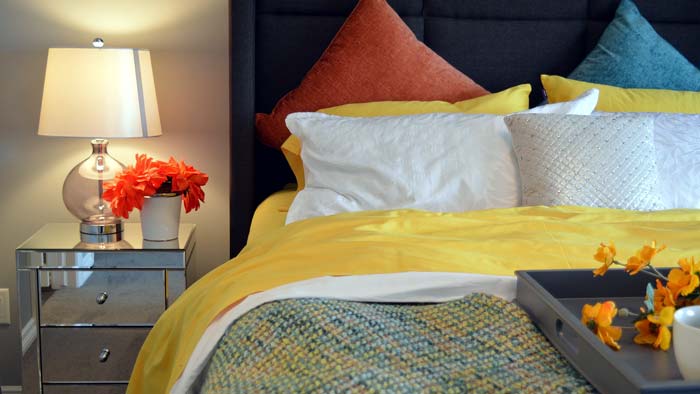 Photo of a bedroom with an attractive light fixture on the side table