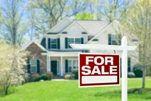 Photo of a home with a for sale sign