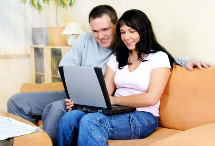 Photo of a couple home shopping on the Internet