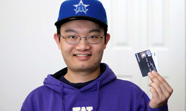 Photo of a young man with some credit cards